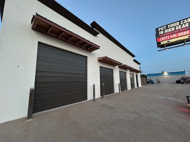 Technicians coordinating Commercial Installs inside a Fort Worth - TX service facility during equipment setup, Specialist performing garage door repair on a sticking track system at a Parker County - TX residence