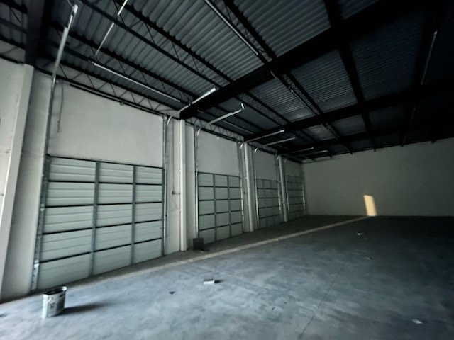 Commercial Installs in Fort Worth - TX as a crew measures a business entry system