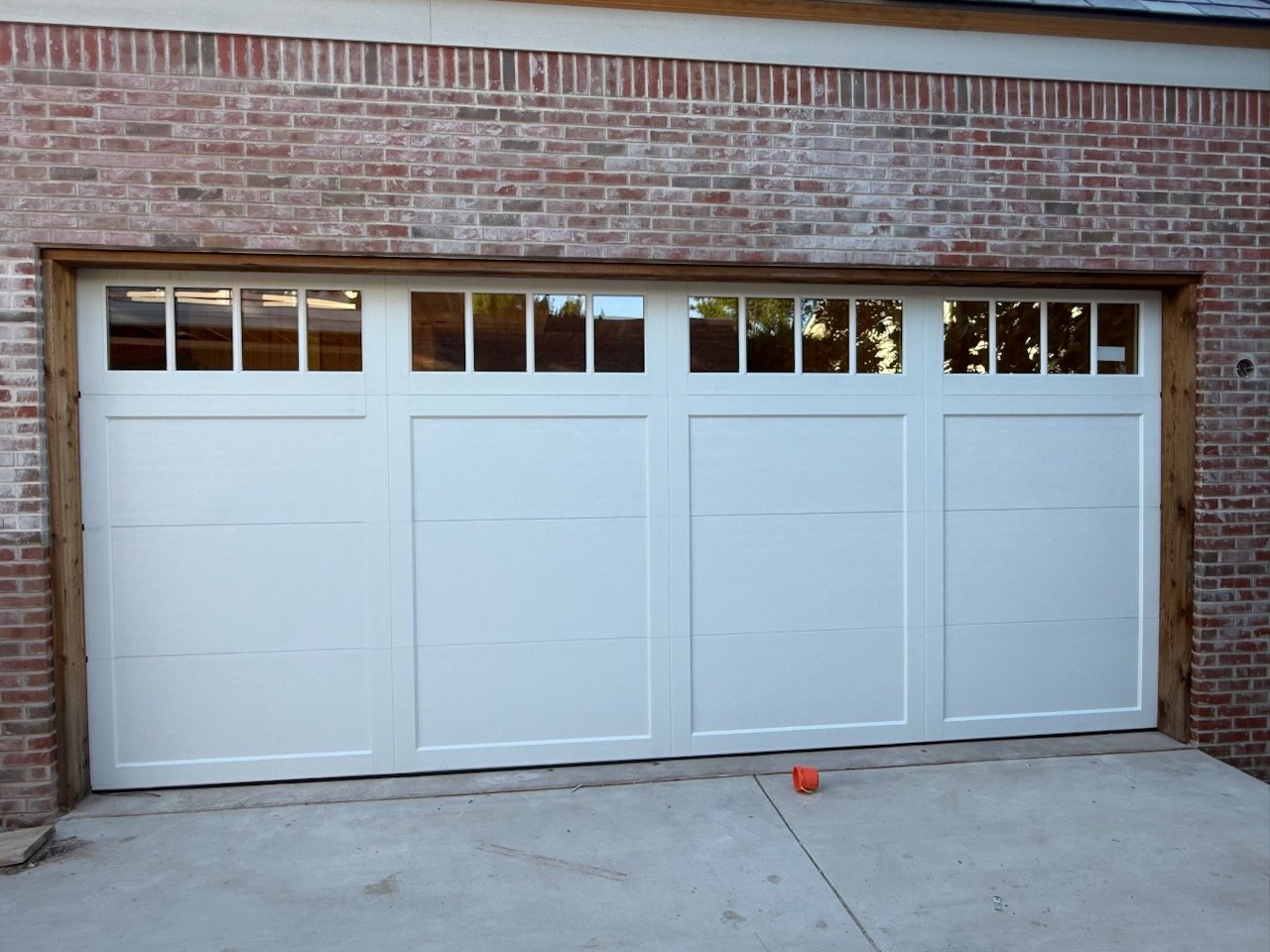 Garage Door Replacement in Fort Worth - TX underway as installers secure new panels on a residential garage