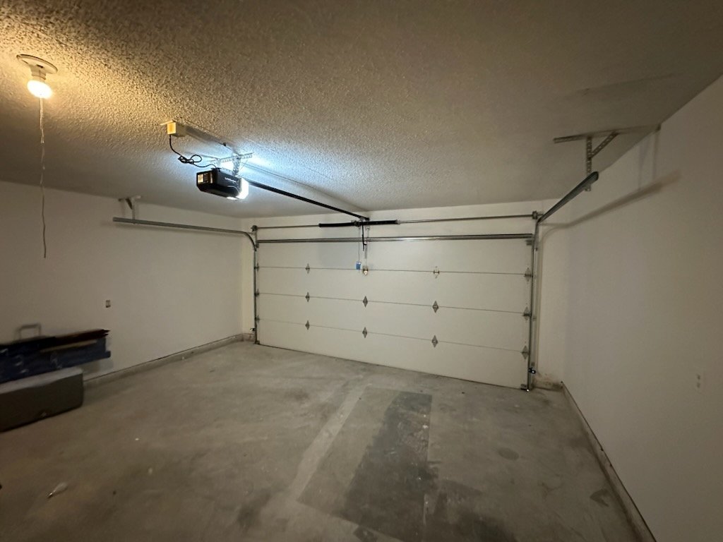 Garage Door Replacement in Fort Worth - TX underway as installers secure new panels on a residential garage