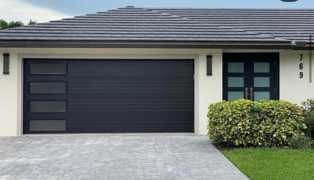 Garage Door Replacement in Fort Worth - TX underway as installers secure new panels on a residential garage, Garage Door Installation in Southlake - TX as installers position custom panels on a front-entry garage