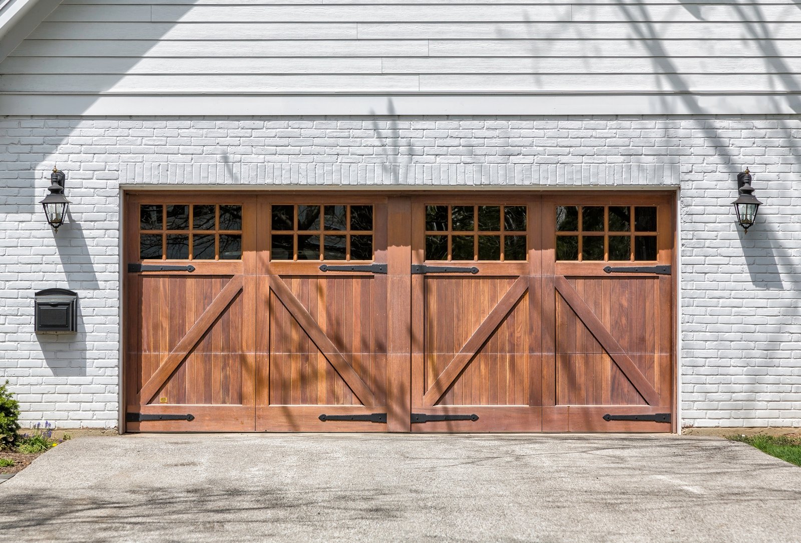 Technician performing garage door replacement adjustments at a Fort Worth - TX home with alignment tools, Garage Door Repair in Tarrant County - TX technician adjusting a misaligned residential garage door track