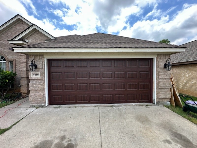 Technician performing garage door replacement adjustments at a Fort Worth - TX home with alignment tools, Garage Door Repair in Tarrant County - TX technician adjusting a misaligned residential garage door track, Garage Door Repair in Parker County - TX technician replacing worn rollers on a residential overhead door, Technician performing garage door repair on an Arlington - TX home with misaligned safety sensors, Garage Door Repair in North Richland Hills - TX technician replacing worn rollers on a residential overhead door