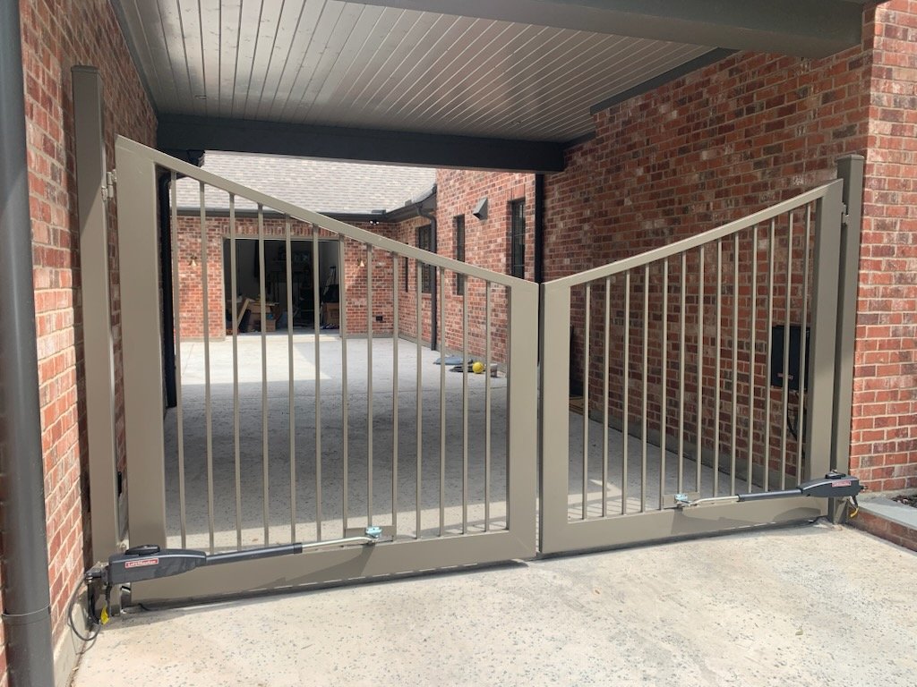 Technician performing gate service and install adjustments at a Fort Worth - TX driveway entrance
