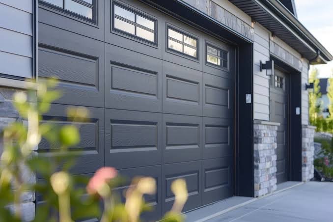 Specialist performing garage door repair and maintenance on worn rollers at a Fort Worth - TX residence, Garage Door Installation in Fort Worth - TX as a technician secures new tracks on a residential garage